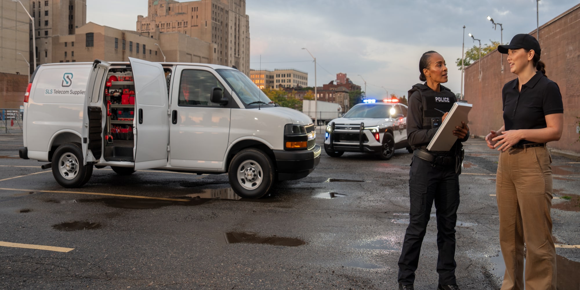 A cop interviewing a driver while their van is parked with the side door open. 